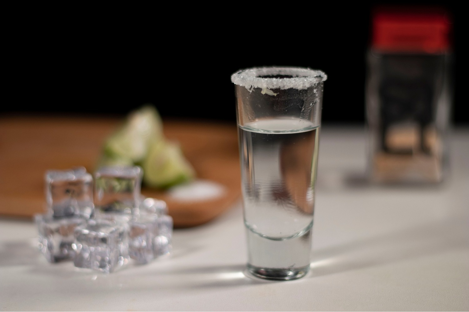 Shot glass with salted rim on a table.