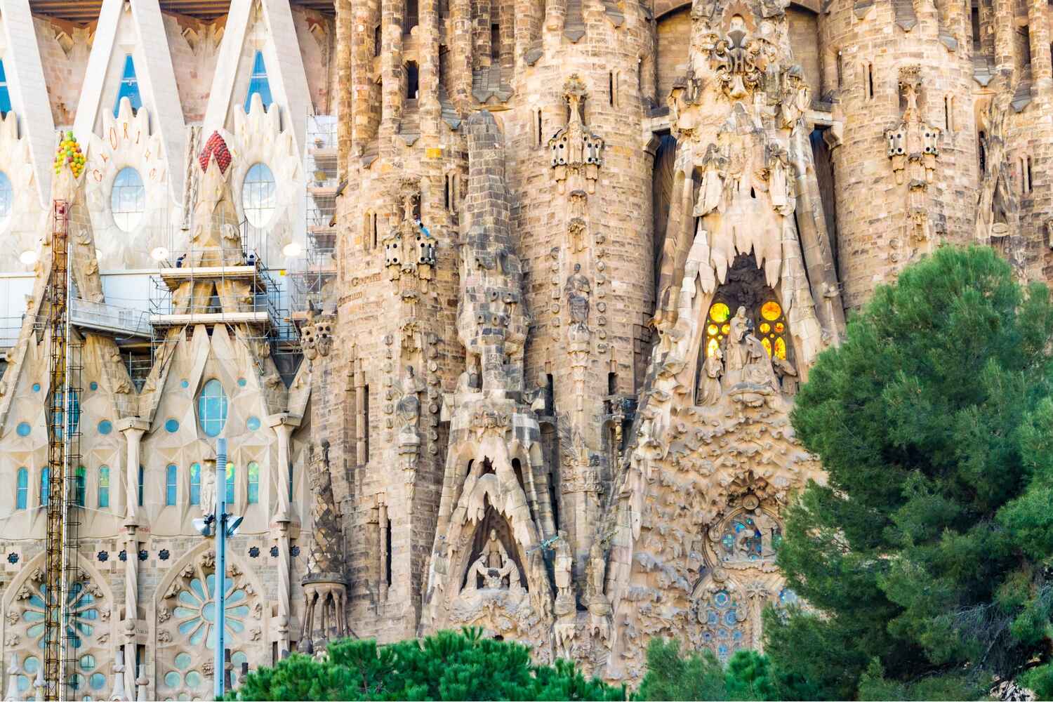 Close-up of La Sagrada Familia's Nativity façade with intricate sculptures and spires in Barcelona.