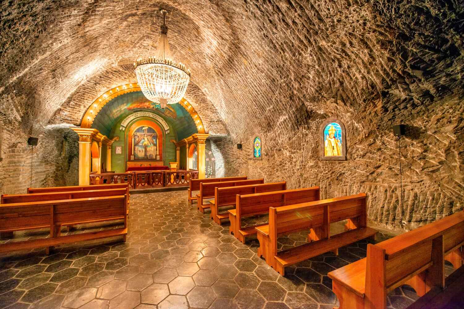 Underground chapel with benches and candles.
