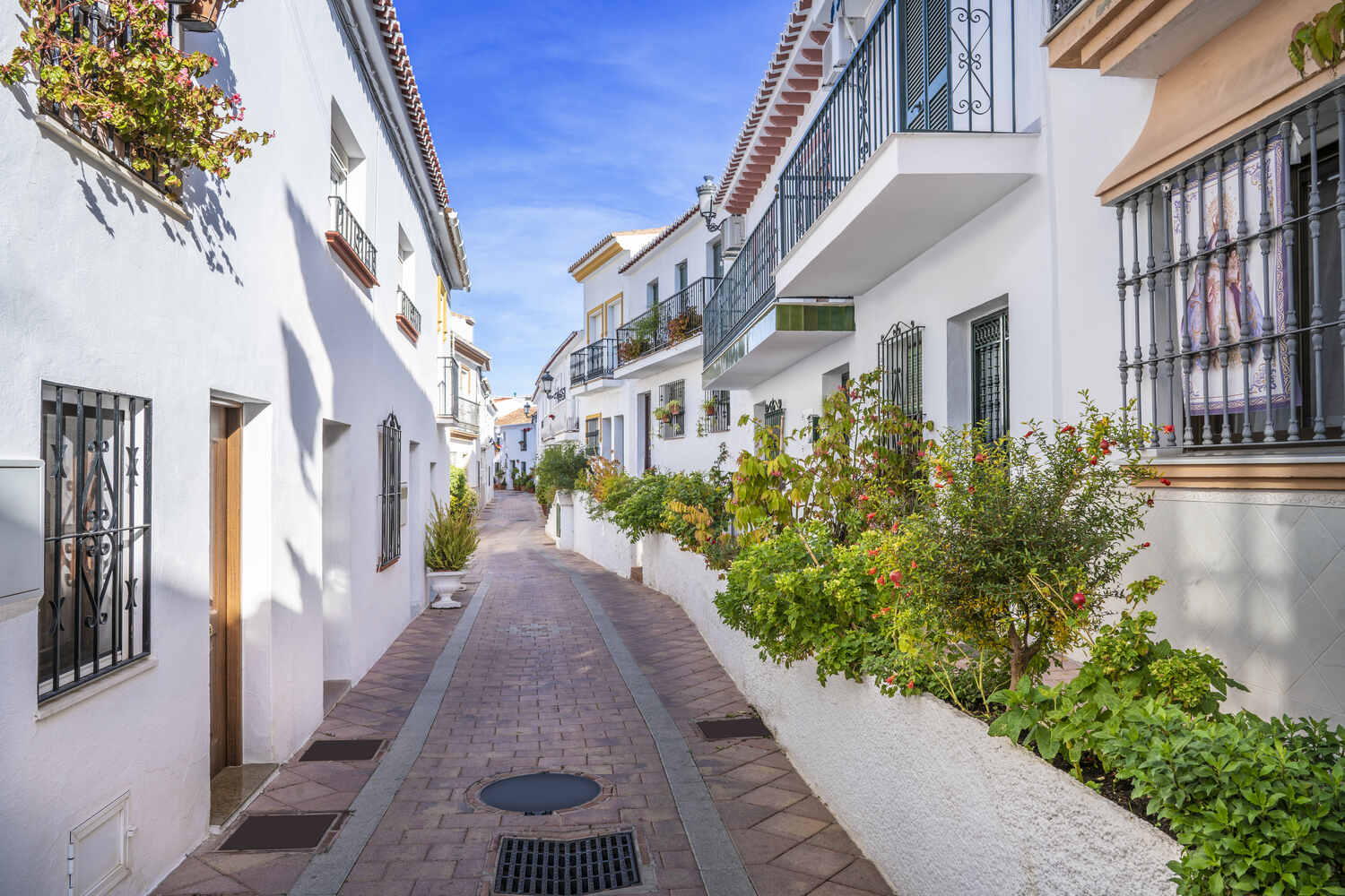 Sunny-street-in-Benalmadena-with-potted-plants white villages in andalucia