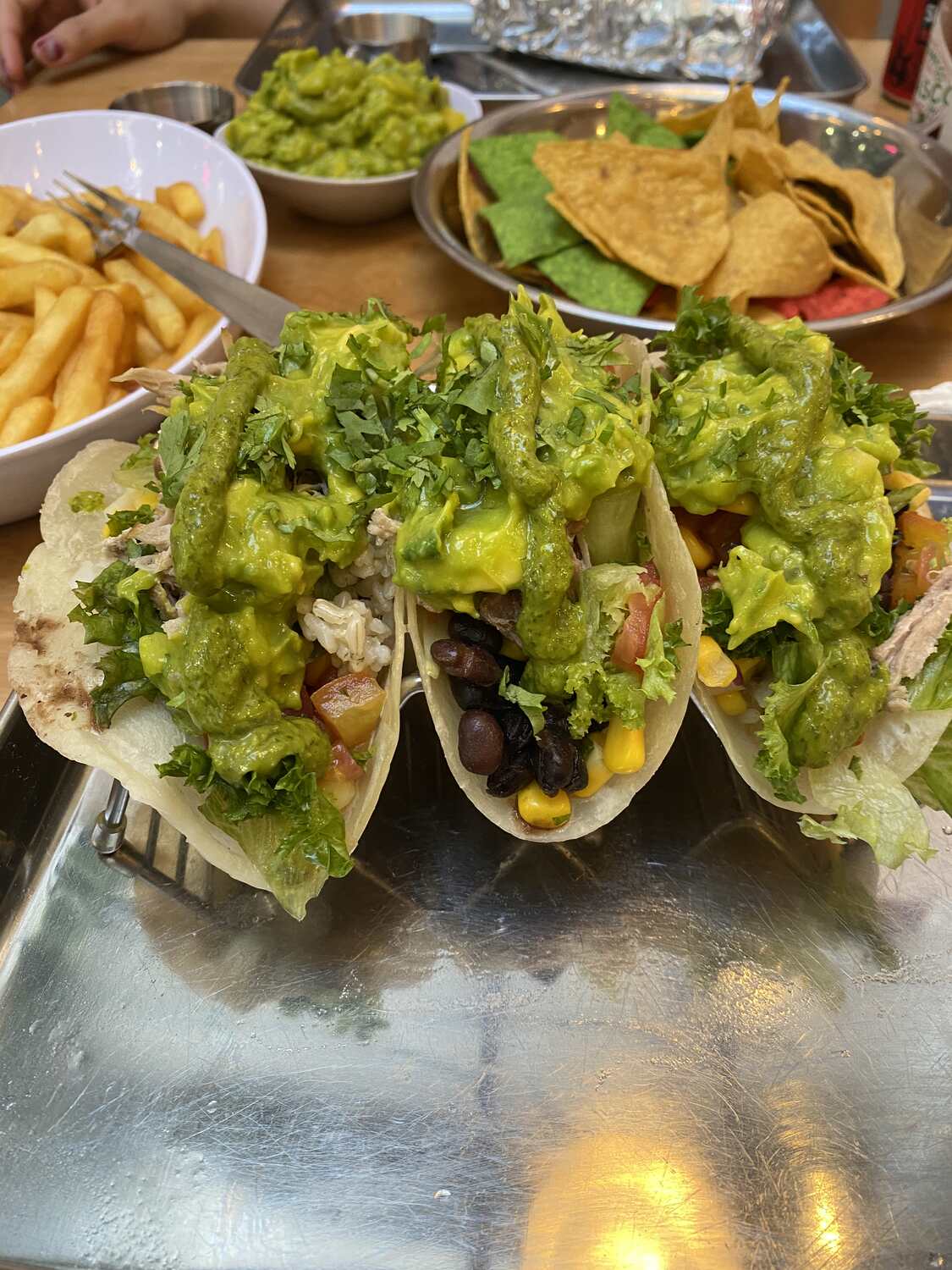 Tacos and nachos on a table at Adobo Mexican grill