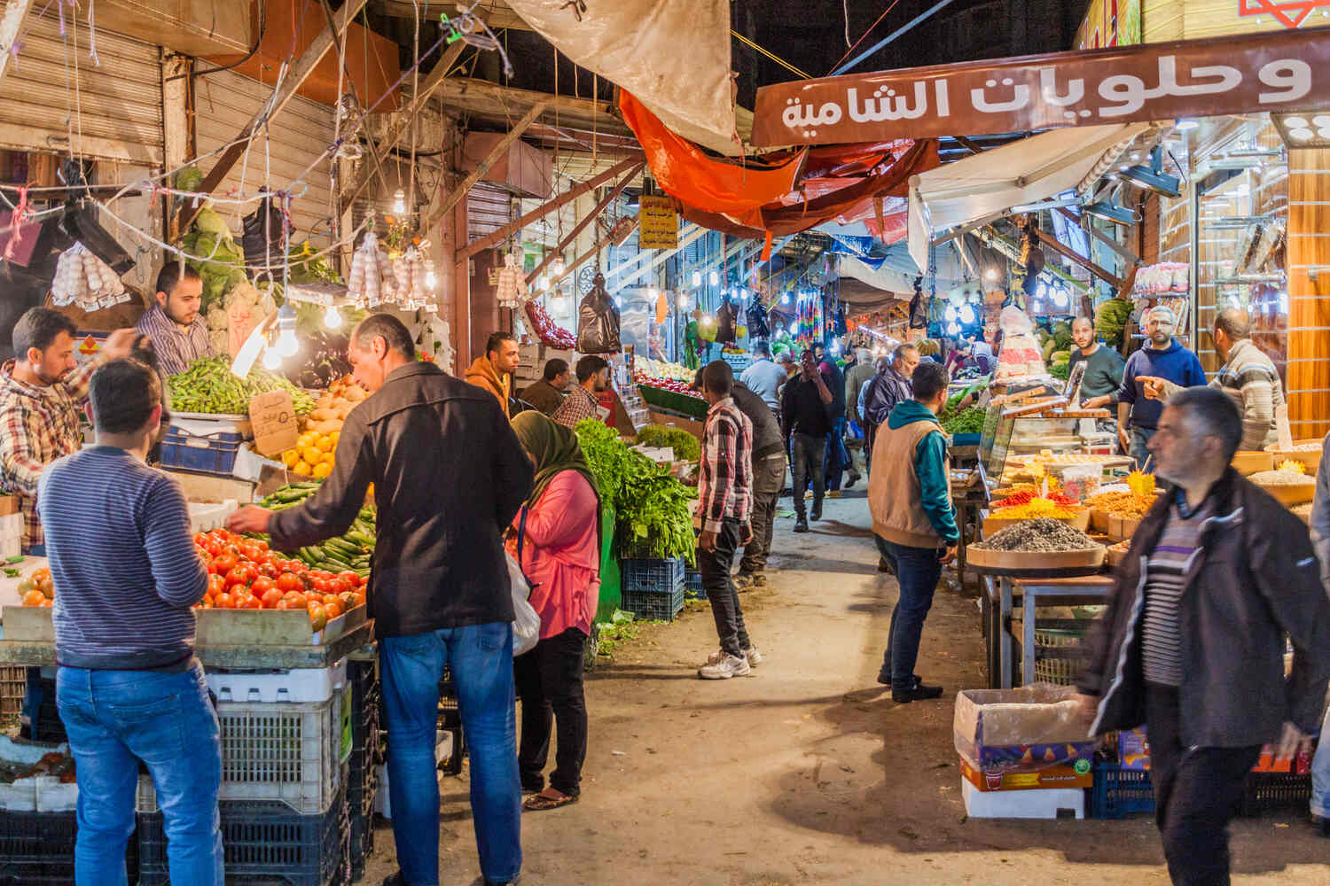 Bustling street market in Amman with fruit stalls.