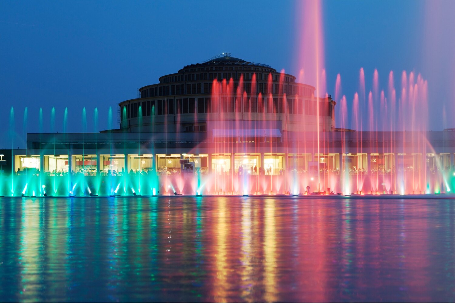 Colorful fountain lit at night.
