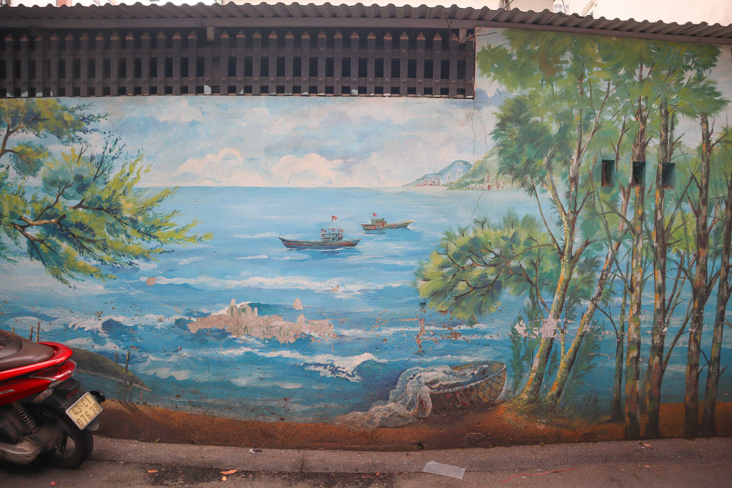 Beautiful graffiti depicting the Son Tra Peninsula and boats at Da Nang Fresco Village