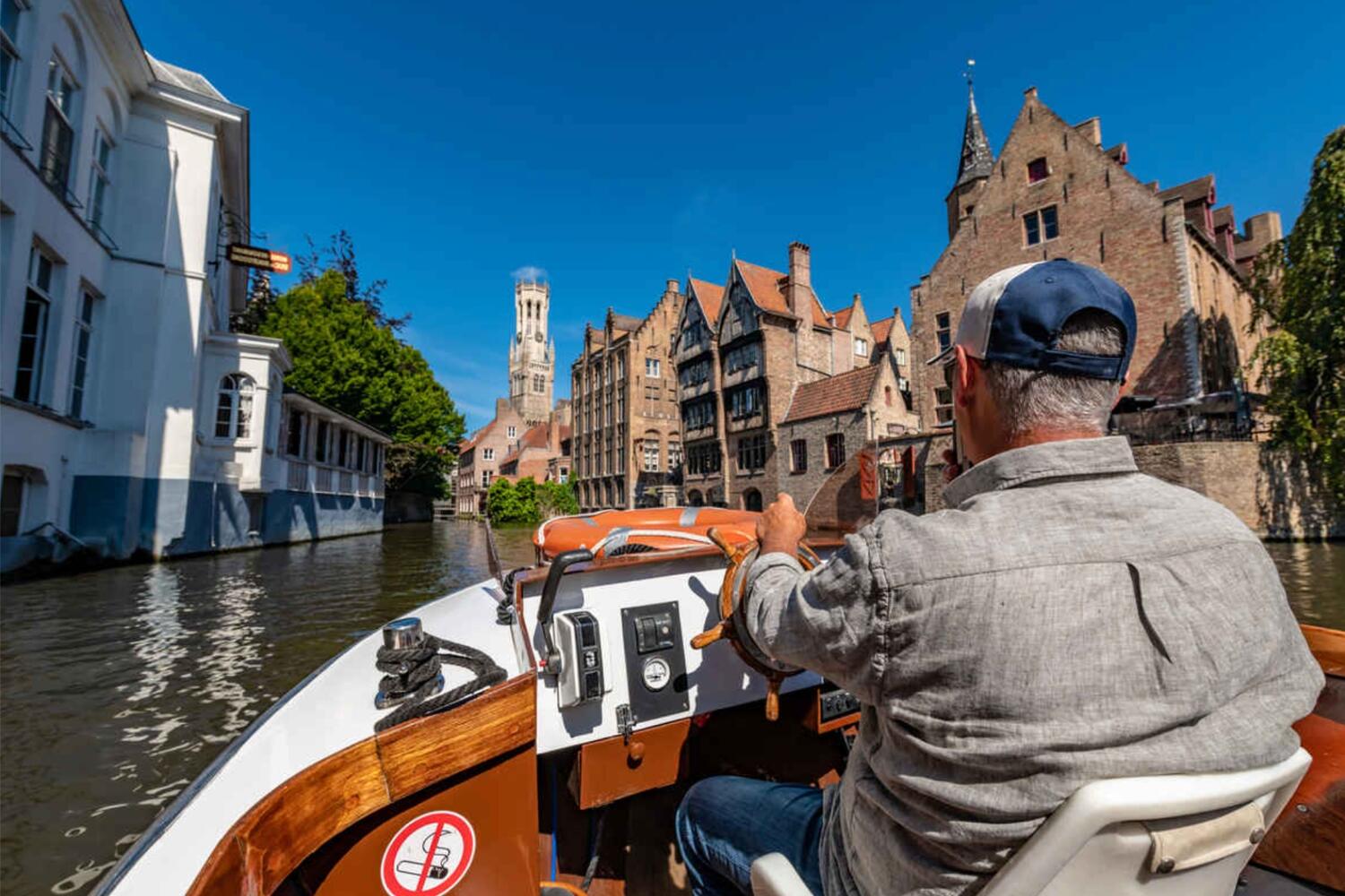 Boat captain on a boat on a Bruges Canal Cruise